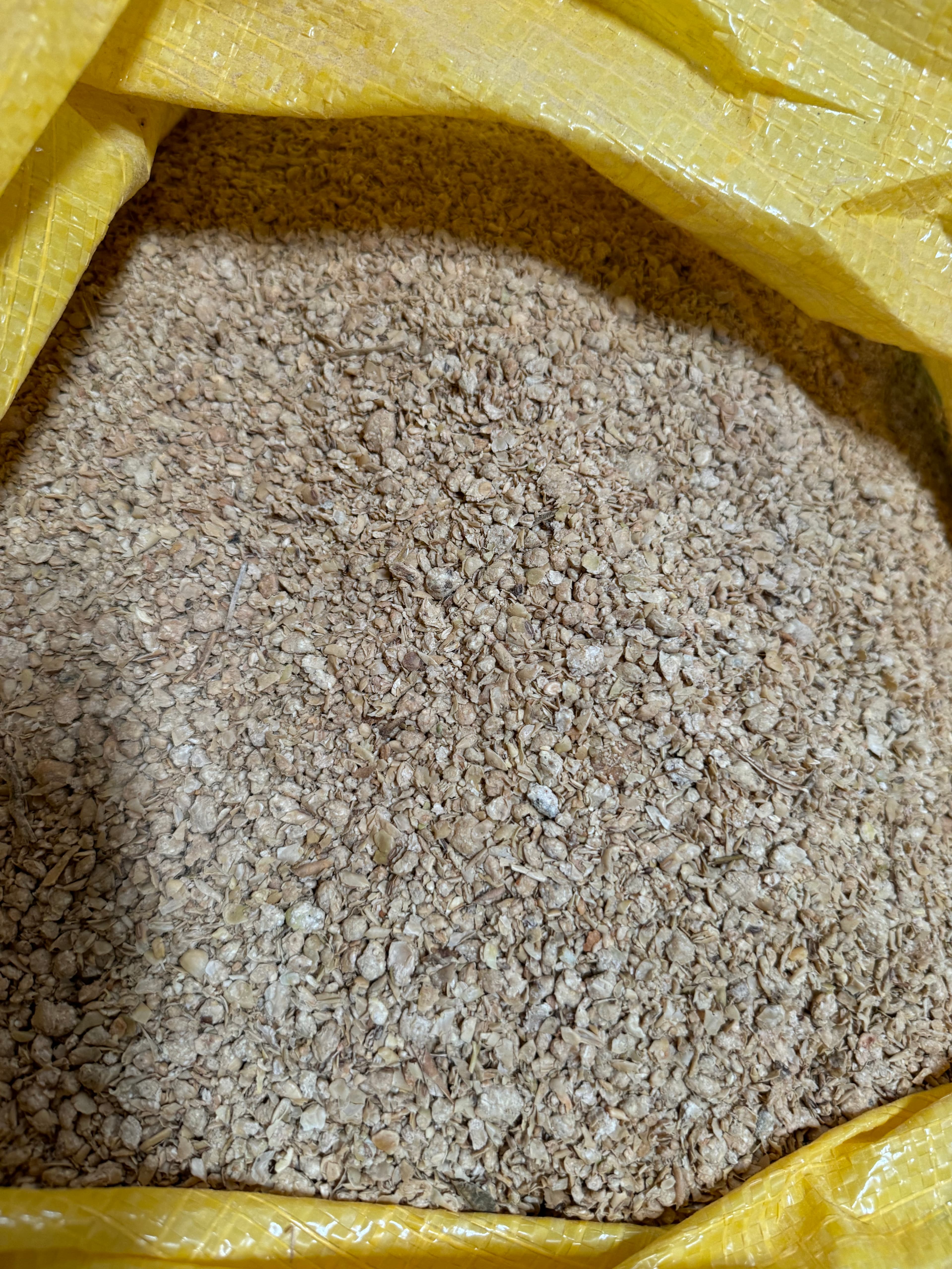 Top-down view of soybean meal inside an open sack